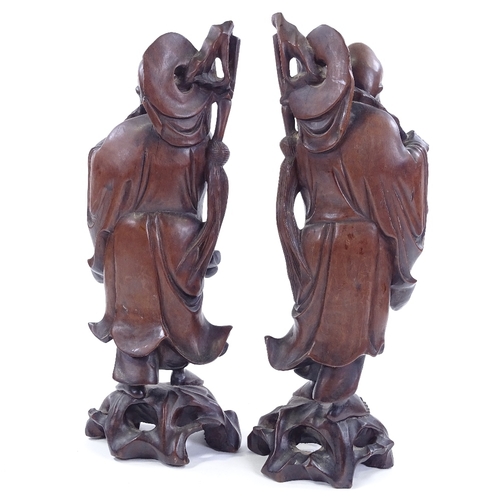 93 - A pair of oriental carved hardwood figures, largest height 36.5cm