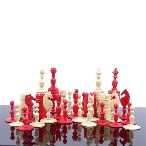 94 - A 19th century natural and red stained bone chess set, King height 10cm, together with inlaid wood b... 