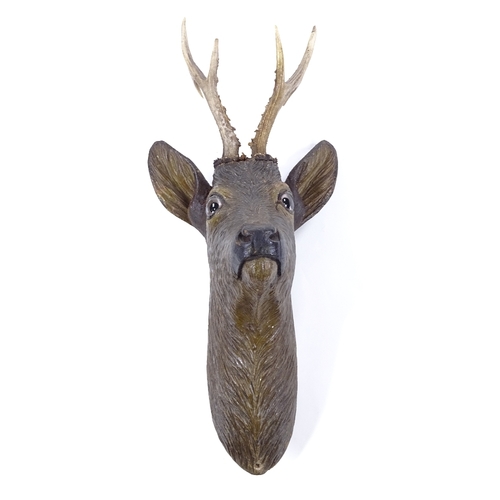 97 - A Black Forest carved and painted wood wall-mounted deer's head, with horn antlers and glass eyes, o... 