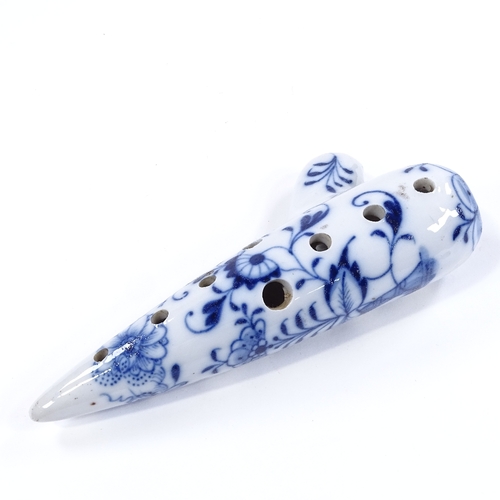 99 - A Continental blue and white porcelain ocarina flute, length 17.5cm