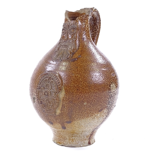 113 - A salt glaze Bellarmine stoneware flagon, 16th/17th century, height 20cm, A/F