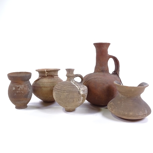 198 - A group of terracotta Antiquities, comprising a Roman narrow necked jug, height 19cm, and 4 smaller ... 