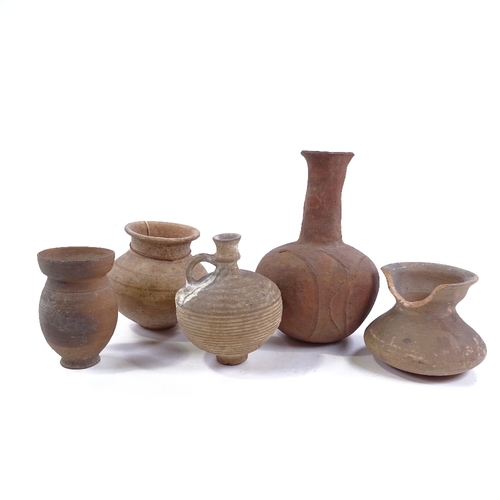 198 - A group of terracotta Antiquities, comprising a Roman narrow necked jug, height 19cm, and 4 smaller ... 