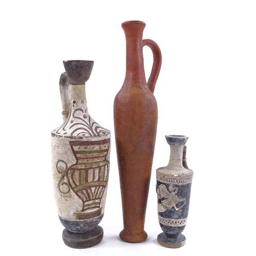 199 - A group of terracotta Antiquities, comprising a tall narrow flask, height 30cm, and 2 Greek ewers wi... 