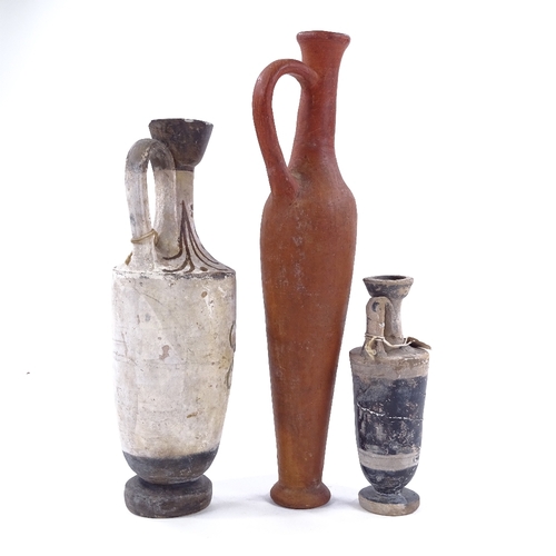 199 - A group of terracotta Antiquities, comprising a tall narrow flask, height 30cm, and 2 Greek ewers wi... 