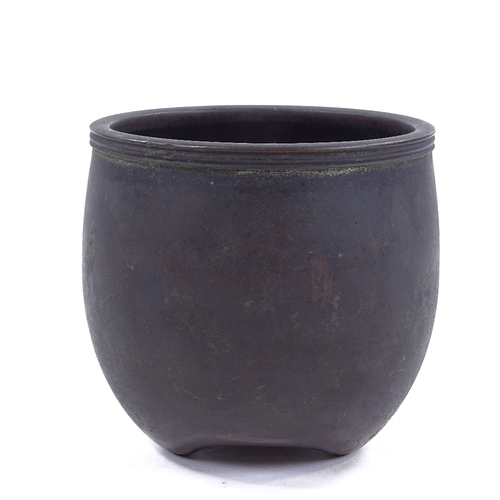 204 - A Chinese patinated bronze pot on 3 feet, signed under base, height 10cm, rim diameter 10.5cm, prove... 