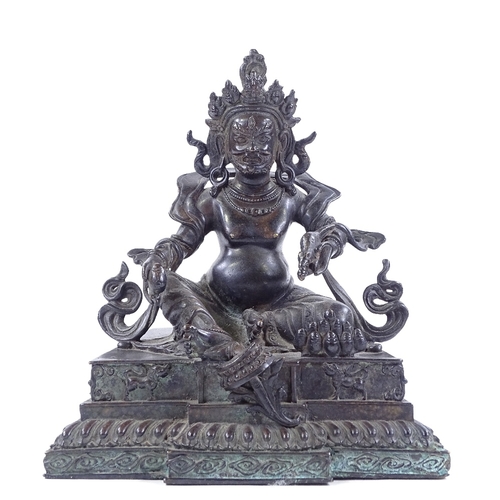 225 - A Chinese patinated bronze deity, height 21cm