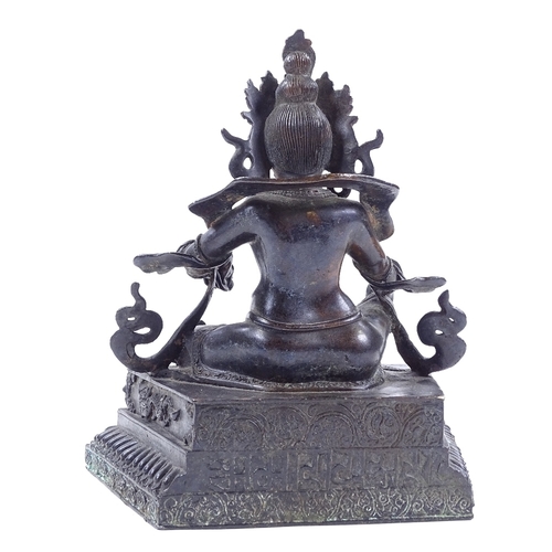 225 - A Chinese patinated bronze deity, height 21cm