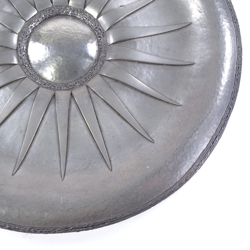 244 - Rene Delavan, large mid-20th century pewter charger, hand beaten with applied sun ray motif, cast ed... 