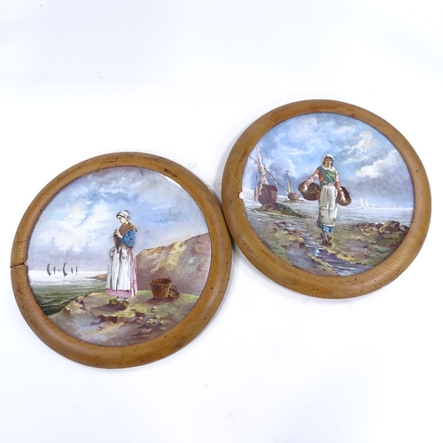 251 - A pair of large 19th century French ceramic wall plates, with hand painted designs of fisher girls, ... 