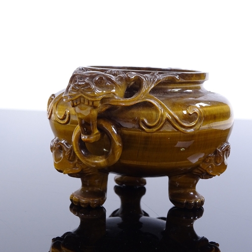 256 - A Chinese pot carved from a single piece of tiger's eye, with dragon ring handles and carved dragon ... 