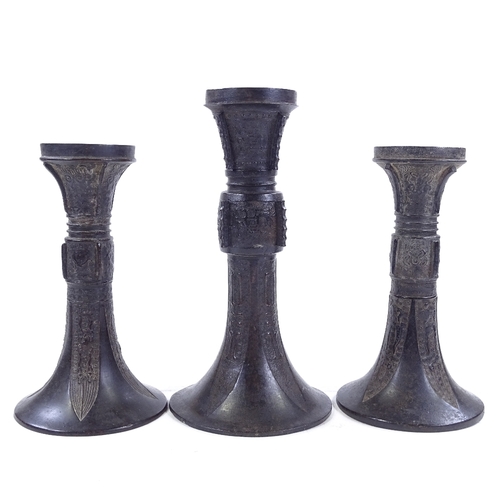 258 - 3 Chinese patinated bronze trumpet-shaped Gu vases, with relief moulded decoration, largest height 2... 