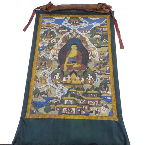 229 - An Oriental watercolour thangka on linen, depicting a seated Buddha, in green silk surround with fin... 