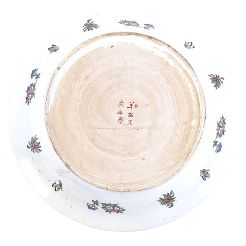 253 - A large Chinese Canton-decorated famille rose bowl, courtyard, bird and floral scenes, 6 character m... 