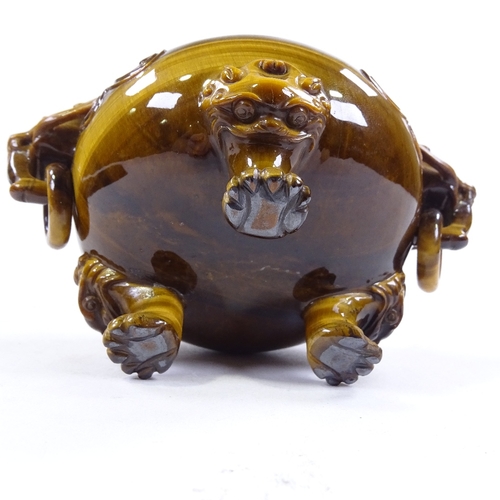 256 - A Chinese pot carved from a single piece of tiger's eye, with dragon ring handles and carved dragon ... 