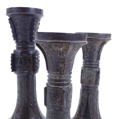 258 - 3 Chinese patinated bronze trumpet-shaped Gu vases, with relief moulded decoration, largest height 2... 