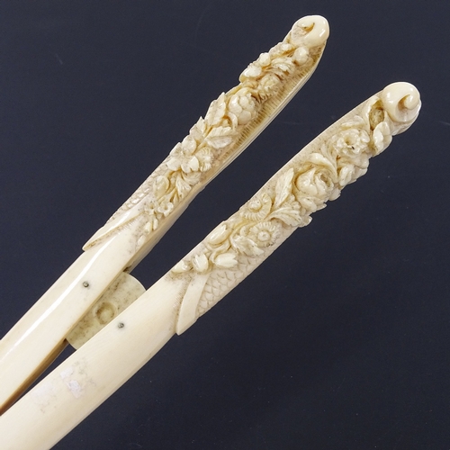 282 - A pair of 19th century ivory glove stretchers, with relief carved floral handles, length 22cm