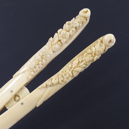 282 - A pair of 19th century ivory glove stretchers, with relief carved floral handles, length 22cm