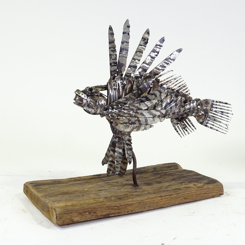 1303 - Clive Fredriksson, metal sculpture, lion fish on natural wooden base, base length 16