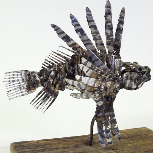 1303 - Clive Fredriksson, metal sculpture, lion fish on natural wooden base, base length 16