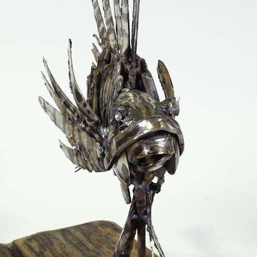 1303 - Clive Fredriksson, metal sculpture, lion fish on natural wooden base, base length 16