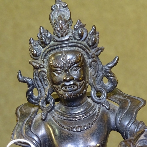 225 - A Chinese patinated bronze deity, height 21cm