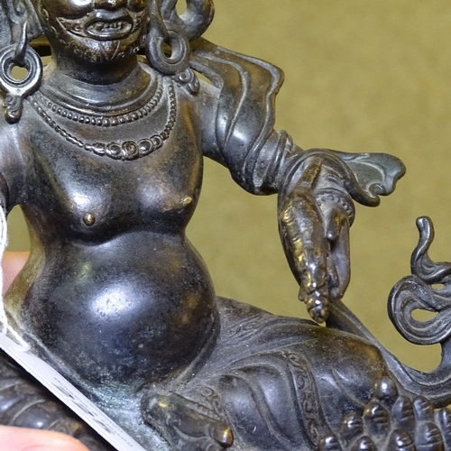 225 - A Chinese patinated bronze deity, height 21cm