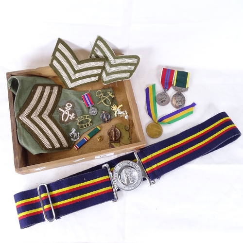 149 - Various militaria, including Liberation of Jersey medal, Coronation medal, cap badges etc