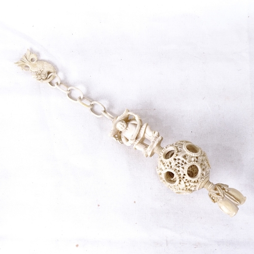 170 - An ornate carved and pierced ivory puzzle ball on chain, circa 1900, overall length 25cm