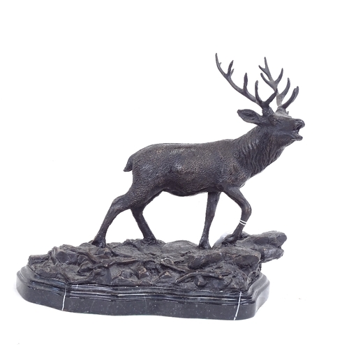 218 - After Mene, patinated bronze sculpture, stag on rocky outcrop, signed, on black marble base, base le... 