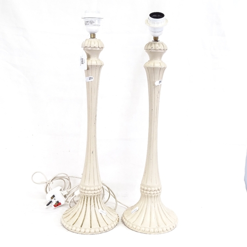 251 - A Middle Eastern brass and black enamel table lamp, and a pair of cream painted wood table lamps, br... 