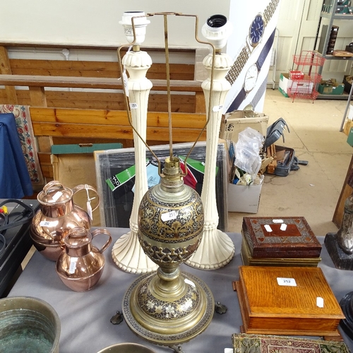 251 - A Middle Eastern brass and black enamel table lamp, and a pair of cream painted wood table lamps, br... 