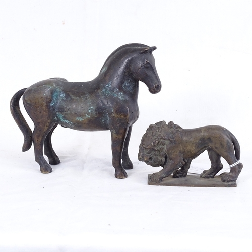 286 - A heavy cast-brass horse and lion, horse length 17cm (2)