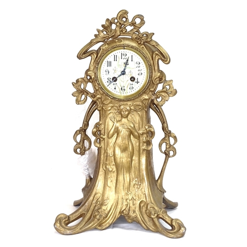 40 - A French Art Nouveau gilded spelter-cased mantel clock, ornate stylised case with relief moulded fem... 