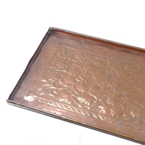 67 - An Art Nouveau Keswick School of Industrial Arts rectangular copper tray, relief embossed floral dec... 