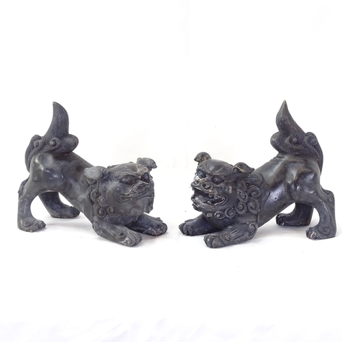 105 - A pair of Oriental black painted brass Dogs of Fo, height 14cm