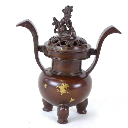 123 - A Chinese polished bronze 2-handled censer, mark on base the dog knop, overall height 14.5cm