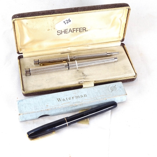 126 - A cased Sheaffer fountain and ballpoint pen set, and a Watermans 502 fountain pen, boxed (3)