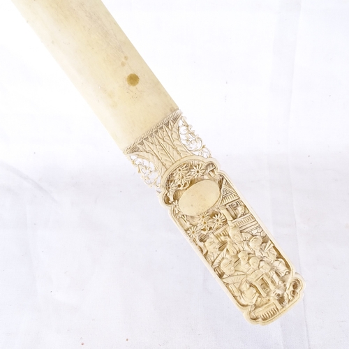 127 - An Oriental carved ivory page turner, with relief court scene handle, length 33cm