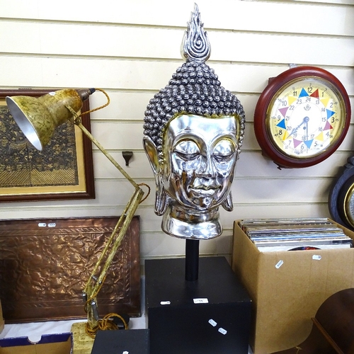 73 - A modern silvered plaster Buddha head sculpture, on square wood stand, overall height 95cm