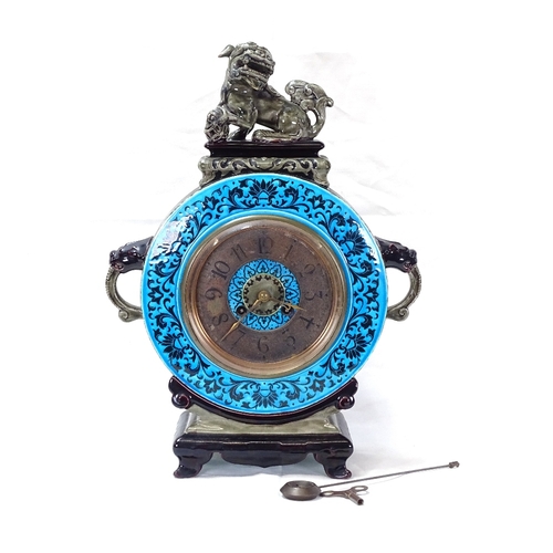 89 - A French Aesthetic Movement Majolica Clock,
turquoise and green glaze case in Chinese taste with Dog... 