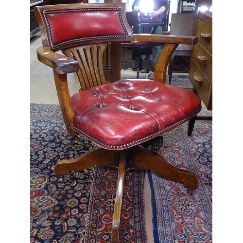 1406 - A late Victorian oak and studded leather upholstered swivel desk chair