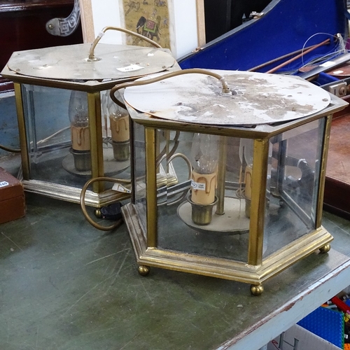 462 - A pair of hexagonal brass-framed lanterns with bevelled-edge panels, 29cm across