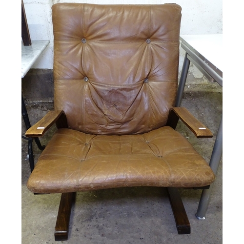 1477 - A Danish style teak and brown leather upholstered armchair