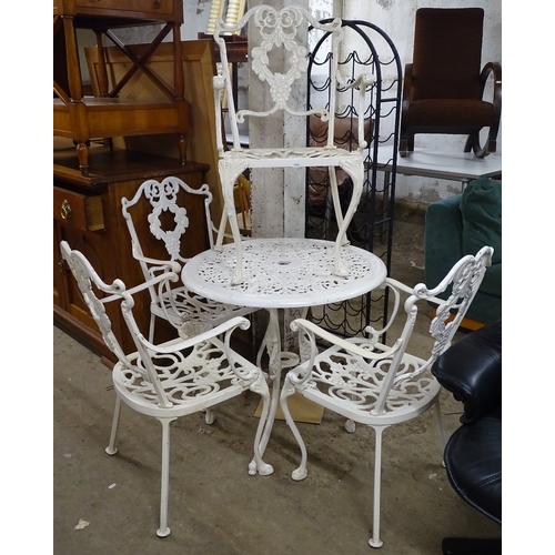 1492 - A painted aluminium garden circular table, and 4 matching armchairs