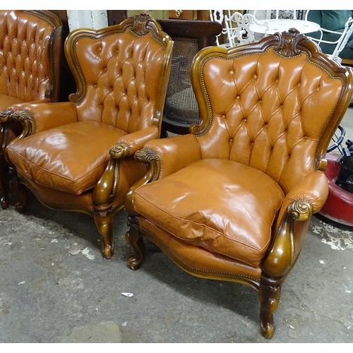 1509 - A pair of Continental design beech-framed and studded upholstered wing armchairs, on cabriole legs