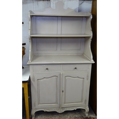 1573 - A painted Continental style dresser, with open plate rack, drawers and cupboards under, on scrolled ... 