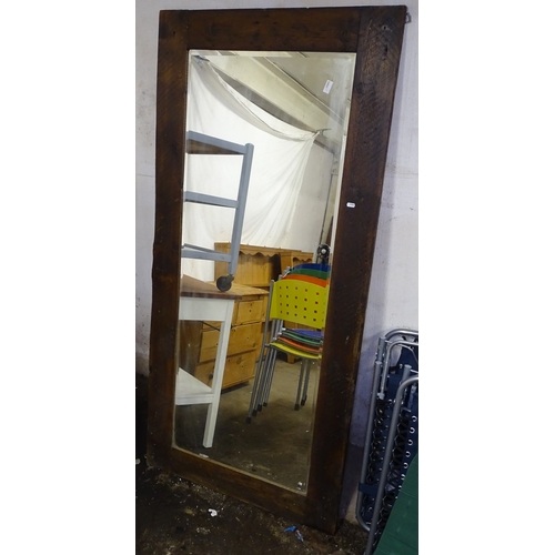 1592 - A rectangular rustic-framed bevelled-edge wall mirror, 84cm x 176cm