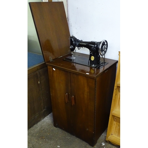 1596 - A Vintage walnut-cased Singer treadle sewing machine no. 201K, and accessories