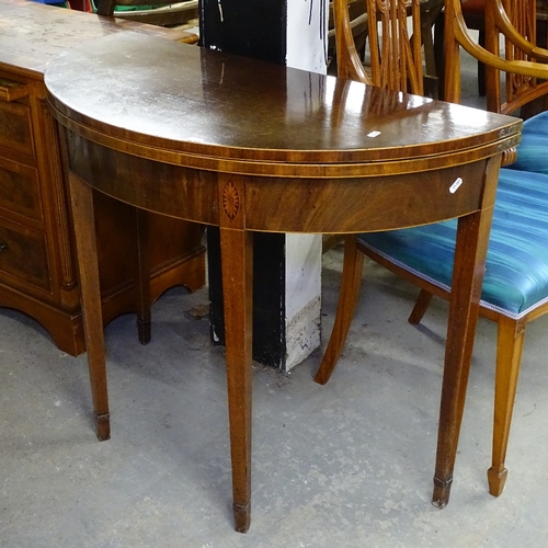 1624 - A 19th century mahogany demilune fold over card table, with marquetry decoration, raised on square t... 